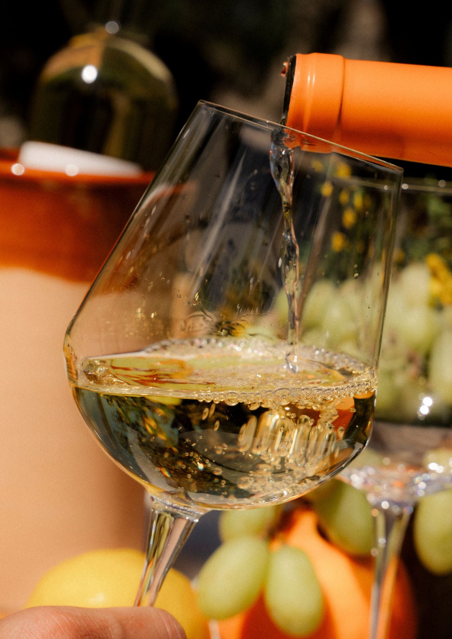 orange wine poured in wine glass